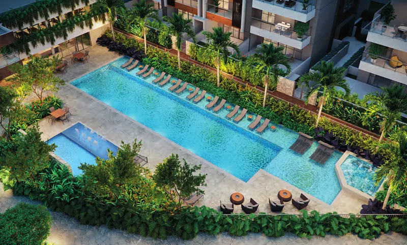 Vista aérea das piscinas do Claris Casa & Clube com deck molhado, hidromassagem e jardins